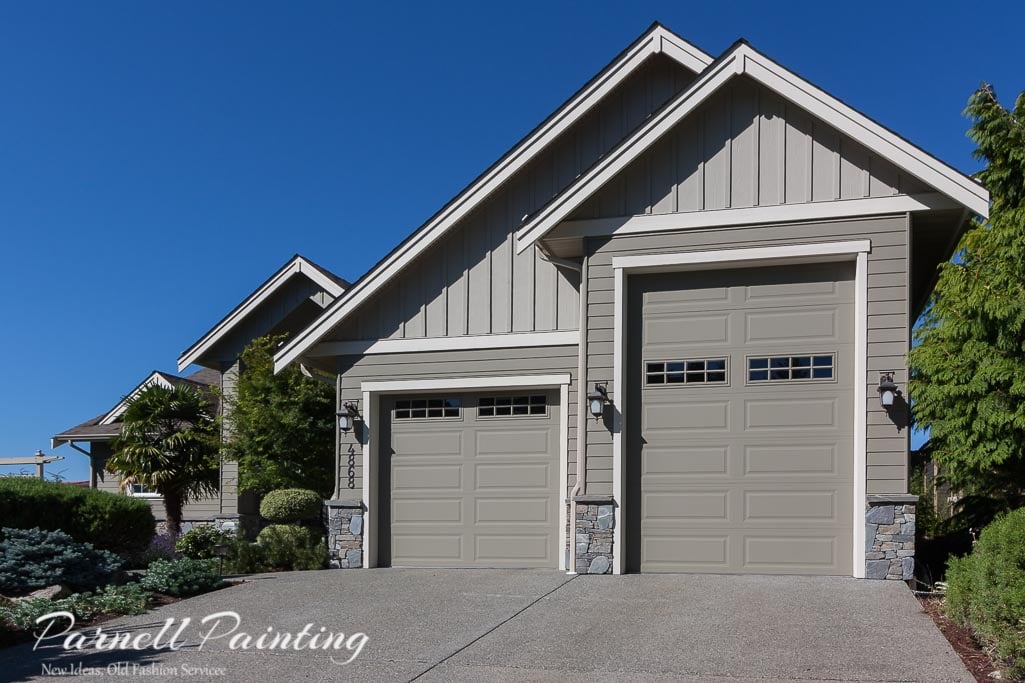 After exterior painting of Nanaimo house with green-grey siding, light grey trim, and lighter gable accents