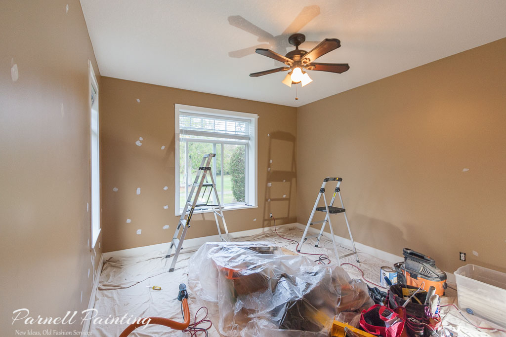 room with drop sheets on the floor and equipment being prepared for an professional interior paint job by Parnell Painting in Nanaimo