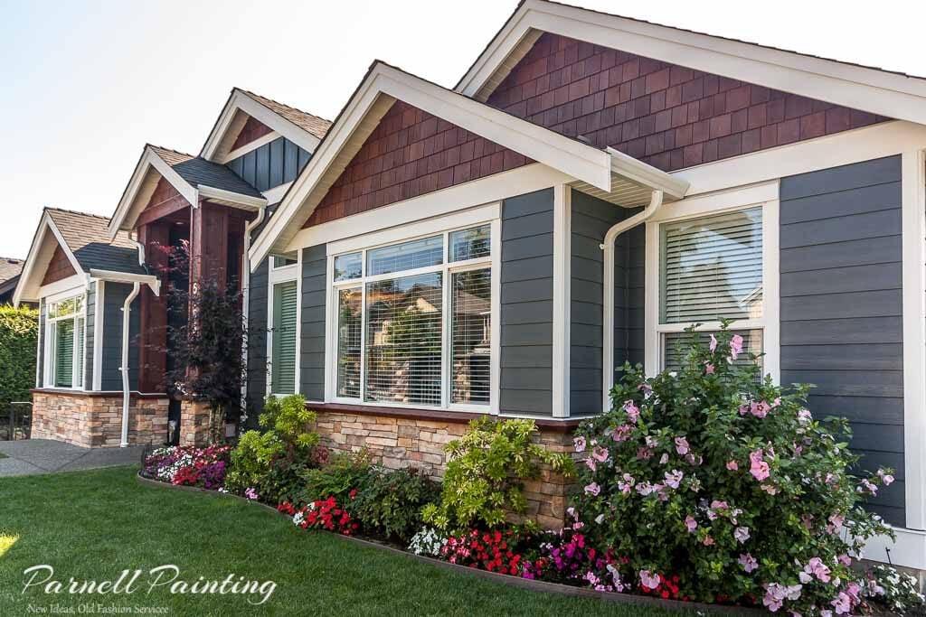 A house with Hardie board siding painted iron gray with white trim work
